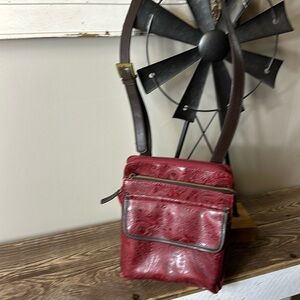 Relic quality brand maroon paisley stamped faux leather. 3 compartments preowned